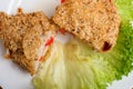 Chicken breast in sesame deep-fried. Chicken fillet stuffed with cheese and bell pepper. Restaurant dish on a white plate