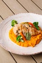 Chicken breast steak with carrot puree baby carrot and broccoli. Grilled chicken slice with baby carrot puree. wooden Royalty Free Stock Photo