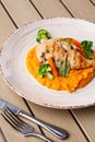 Chicken breast steak with carrot puree baby carrot and broccoli. Grilled chicken slice with baby carrot puree. wooden Royalty Free Stock Photo