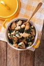 Chicken breast stewed with spinach in a saucepan. Vertical top v Royalty Free Stock Photo