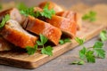 Chicken breast stuffed with stuffing. Sliced chicken rolls, parsley on a wooden board. How to cook stuffed chicken breast. Closeup Royalty Free Stock Photo