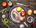 Chicken breast, tomatoes, lemon, onion, on pan rosemary, butter, potatoes, ingredients for cooking on wooden rustic background top