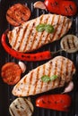 Chicken breast with vegetables in a pan grill top view vertical