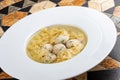 Chicken broth with meatballs and farfallina Royalty Free Stock Photo
