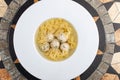 Chicken broth with meatballs and farfallina Royalty Free Stock Photo