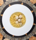 Chicken broth with meatballs and farfallina Royalty Free Stock Photo