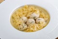 Chicken broth with meatballs and farfallina Royalty Free Stock Photo
