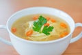 Chicken broth with nudles, carrot and and parsley. Royalty Free Stock Photo