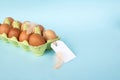 Chicken brown eggs in a recycled cardboard tray with a price tag label. Set of eggs with tag Royalty Free Stock Photo