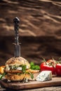 Chicken burger with blue cheese and arugula in a sesame bun on a rustic wood Royalty Free Stock Photo