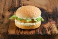 Chicken burger with fresh iceberg lettuce on wooden board Royalty Free Stock Photo