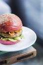 Chicken burger with gherkins beetroot bread bun