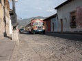Chicken bus on a cobble stone street in Antigua guatemala Royalty Free Stock Photo