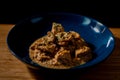 Chicken butter masala curry in a blue bowl garnished with green chopped leaves Royalty Free Stock Photo