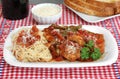 Chicken Cacciatore with pasta and a side of bread.