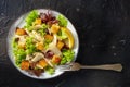 Chicken Caesar salad, shot from above on a black background Royalty Free Stock Photo