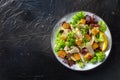 Chicken Caesar salad, shot from above on a dark rustic wooden background Royalty Free Stock Photo