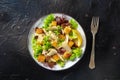 Chicken Caesar salad, shot from the top on a black background Royalty Free Stock Photo