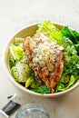 Chicken Ceasar salad. Cos lettuce leaves, grilled chicken breast sliced, parmesan cheese. Restaurant table Royalty Free Stock Photo