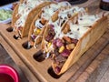 Chicken and cheddar cheese tacos on a taco board with sauces on the side Royalty Free Stock Photo