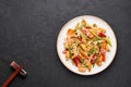 Chicken Chop Suey in white plate at black slate background. Chop Suey is American Chinese cuisine