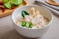 Chicken with coconut milk soup in bowl, Thai food Tom Kha Kai