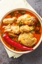 Chicken cooked in spicy gravy made with authentic flavour of malvani closeup on the bowl. Vertical top view Royalty Free Stock Photo