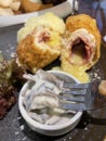 Chicken cordon bleu dish, crispy fried rolled chicken breast stuffed with cheese and ham melted in cream along with salad and mash Royalty Free Stock Photo