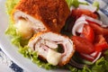 Chicken cordon bleu and fresh vegetable salad closeup. horizontal