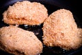 Chicken cordon bleu fried in oil in a frying pan. Selective focus. Toned