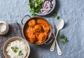 Chicken curry sauce meatballs and rice on a blue background, top view. Indian food. Healthy food