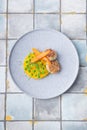 Chicken cutlet with pumpkin puree and green pies, decorated with carrots on tile background