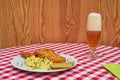 Chicken deep fried schnitzel with mashed potatoes and glass of czech pilsner beer. Royalty Free Stock Photo