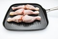 Chicken drumsticks in frying pan