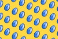 Chicken Easter eggs are painted blue on a yellow-orange background. Pattern. Creative creative easter card. Copy space Royalty Free Stock Photo