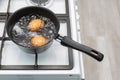 chicken egg with broken shell in boiling water Royalty Free Stock Photo