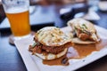 Chicken and Egg Open Sandwitch with Gravy served on a square plate with beer on table Royalty Free Stock Photo