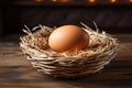 Chicken egg in a wicker nest basket on a wooden table. Royalty Free Stock Photo