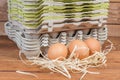 Chicken eggs against of stack of empty pulp egg cartons