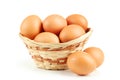 Chicken eggs in basket isolated on white. Royalty Free Stock Photo