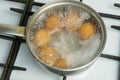 Chicken eggs boil in water. Pan with the product on a gas stove. Royalty Free Stock Photo