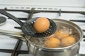 Chicken eggs boil in water. Pan with the product on a gas stove. Royalty Free Stock Photo