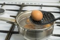 Chicken eggs boil in water. Pan with the product on a gas stove. Royalty Free Stock Photo