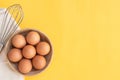 Chicken eggs, brown eggs, broken egg in carton box on yellow background. Top view natural eggs in carton box product concept Royalty Free Stock Photo