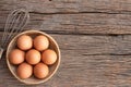 Chicken eggs, brown eggs in carton box on wooden rustic table. Top view eggs bowl. Copy space Royalty Free Stock Photo