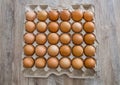 Chicken eggs in a cardboard box on a wooden table. Royalty Free Stock Photo