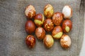 Chicken eggs colored with old-fashioned natural method by onion husks. Brown eggs with different natural patterns on beige burlap