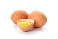 Chicken eggs and half broken egg with yolk  isolated Royalty Free Stock Photo