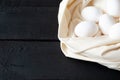Chicken eggs on linen on black background with copy space Royalty Free Stock Photo