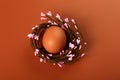 Chicken eggs in a nest on a beige background. Minimalistic Easter concert Royalty Free Stock Photo